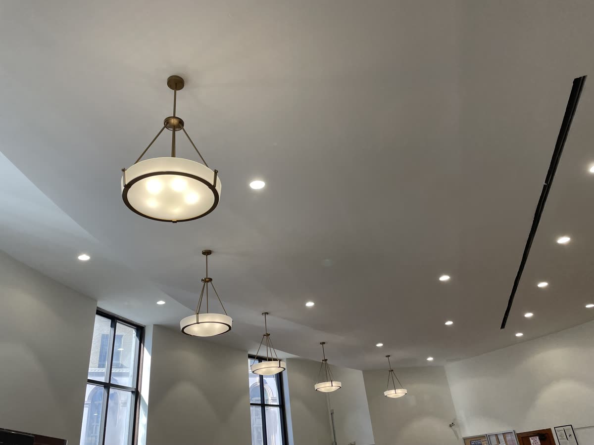 Commercial lobby pendant light installation with recessed lighting